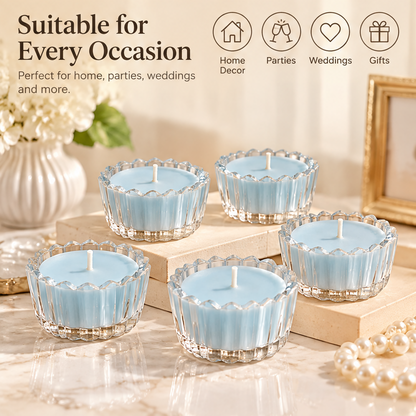 KAELIROAY® Blue Glass Flower Tealight Candle lit in scalloped glass holder on gold bead tray — Create a Warm Atmosphere, Soft candlelight for a calm and cozy space. KAELIROAY gift box with gold lotus logo in background.