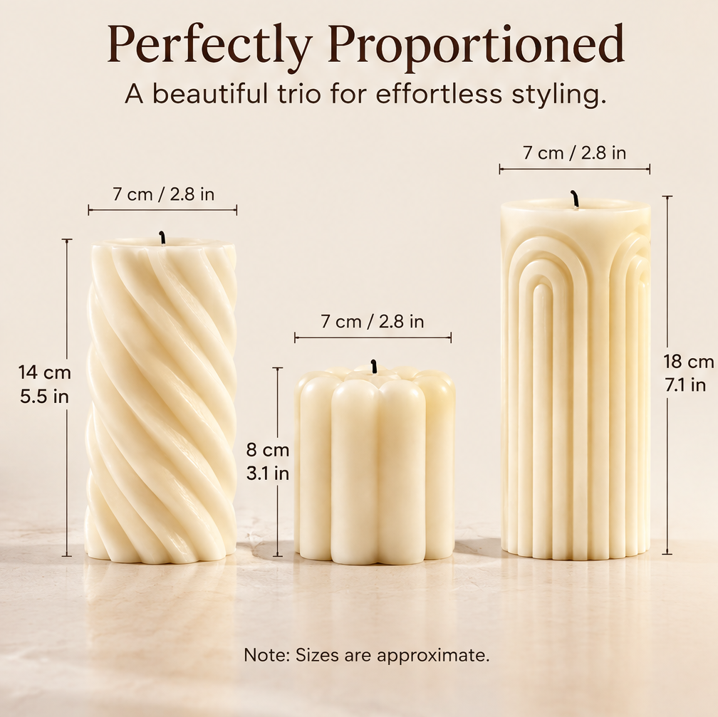 KAELIROAY® Ivory Sculptural Pillar Candle Set on marble tray on living room coffee table — A Warm Glow for a Better Day. More than candles, a feeling. KAELIROAY brand name visible on petal candle.