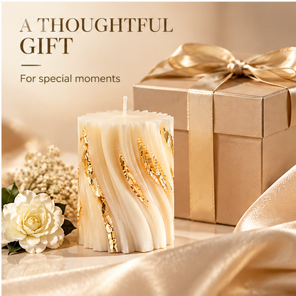 KAELIROAY® Ivory & Gold Leaf Swirl Pillar Candle unlit beside champagne satin ribbon gift box and white rose. A Thoughtful Gift for Special Moments.
